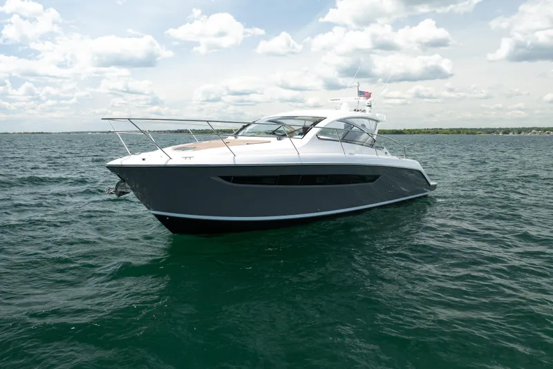 Slide: The Image of 2015 Pursuit SC 365i Sport Coupe cruising on open water under a cloudy sky. - 3