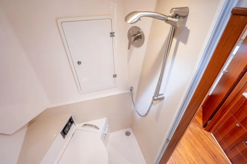 Slide: The Image of Shower area in 2015 Pursuit SC 365i Sport Coupe, featuring modern fixtures and wooden accents. - 33