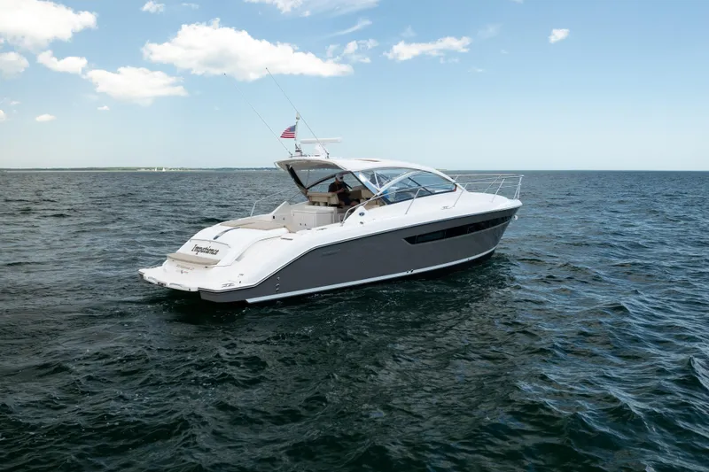 Slide: The Image of 2015 Pursuit SC 365i Sport Coupe cruising on open water under a clear sky. - 4