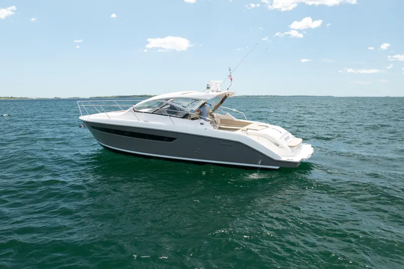 Slide: The Image of 2015 Pursuit SC 365i Sport Coupe cruising on open water under clear skies. - 5