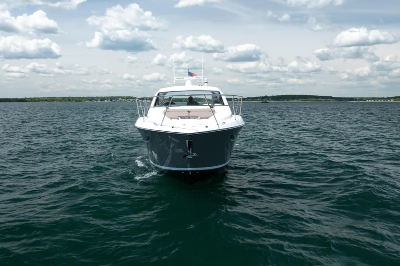Slide: The Image of 2015 Pursuit SC 365i Sport Coupe cruising on open water under a cloudy sky. - 8