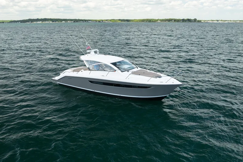 Slide: The Image of 2015 Pursuit SC 365i Sport Coupe cruising on open water under a cloudy sky. - 9