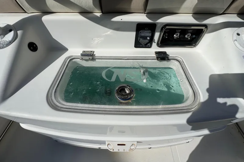 Slide: The Image of 2018 NauticStar 2602 Legacy boat console with livewell and control panel. - 13