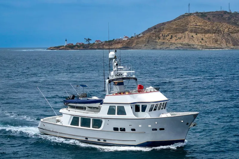 The Image of 1990 Seaton Long Range Cruiser yacht navigating near coastal cliffs. - 0