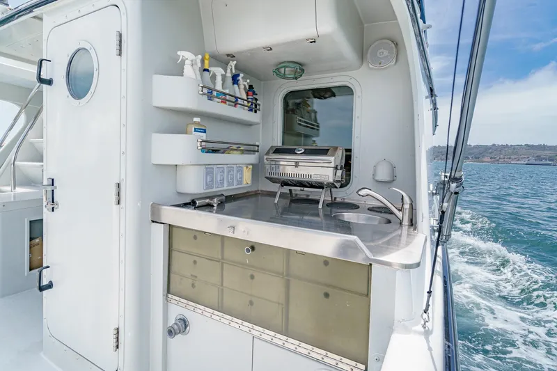 Slide: The Image of Outdoor kitchen on a 1990 Seaton Long Range Cruiser, featuring a grill and sink. - 11