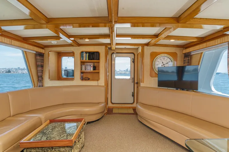Slide: The Image of Luxurious interior of a 1990 Seaton Long Range Cruiser with elegant wood accents and plush seating. - 13