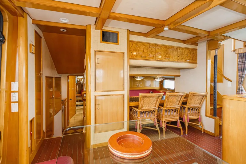 Slide: The Image of Luxurious interior of a 1990 Seaton Long Range Cruiser with wooden furnishings and dining area. - 17