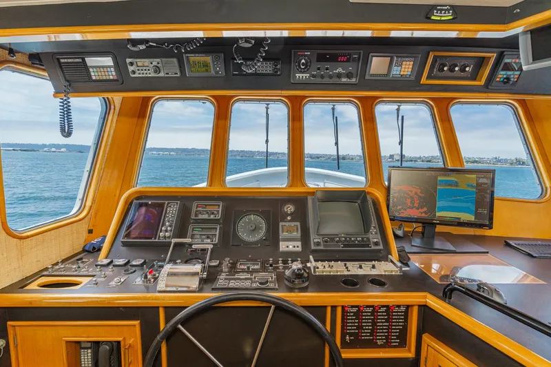 Slide: The Image of Cockpit of a 1990 Seaton Long Range Cruiser with navigation equipment and ocean view. - 21