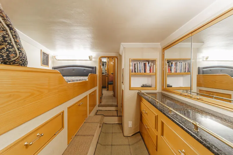 Slide: The Image of Luxurious interior of a 1990 Seaton Long Range Cruiser with wood cabinetry and mirrored surfaces. - 24