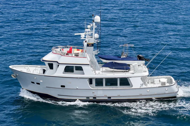 Slide: The Image of Seaton Long Range Cruiser 1990 navigating on open sea, showcasing sleek design and spacious deck. - 3