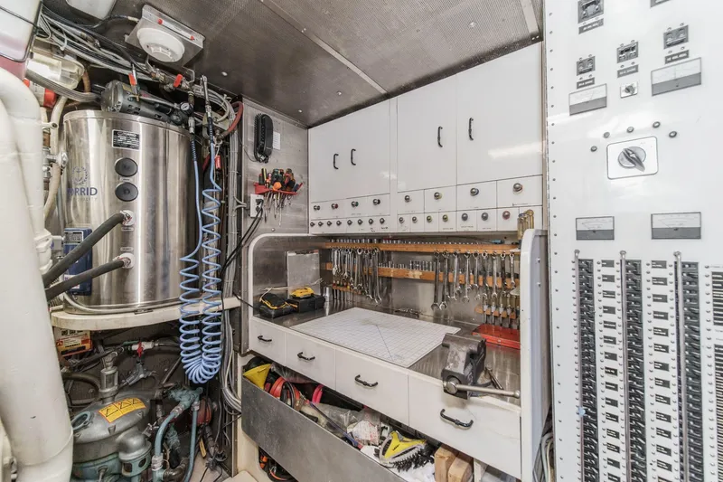 Slide: The Image of Engine room of a 1990 Seaton Long Range Cruiser with tools and control panels. - 31