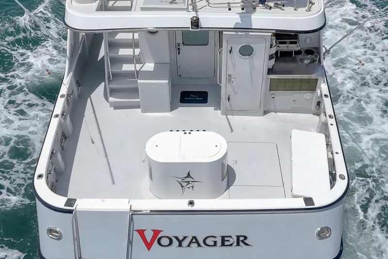 Slide: The Image of Seaton Long Range Cruiser 1990, named Voyager, cruising on open water with spacious deck. - 9
