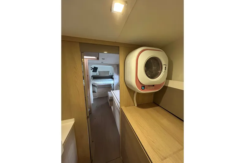 Slide: The Image of Compact laundry area in 2018 Bali 4.1 yacht interior with modern washer. - 17