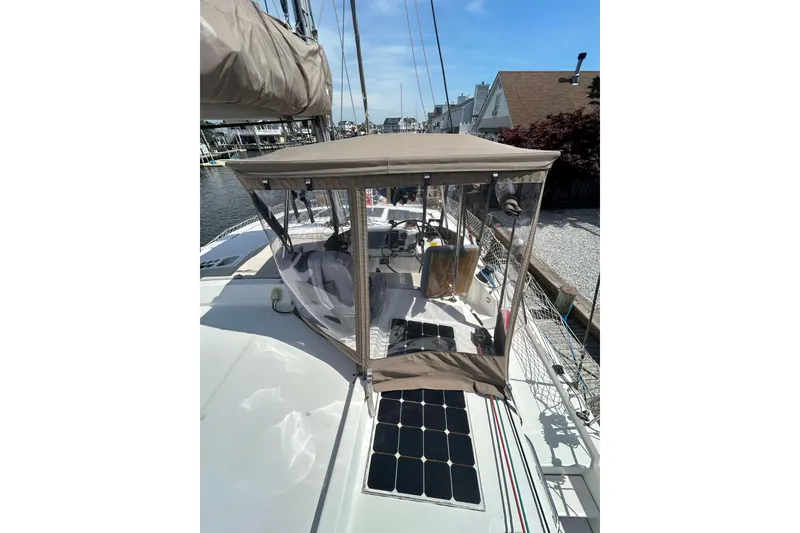 Slide: The Image of 2018 Bali 4.1 catamaran with solar panels and cockpit enclosure in a marina. - 3