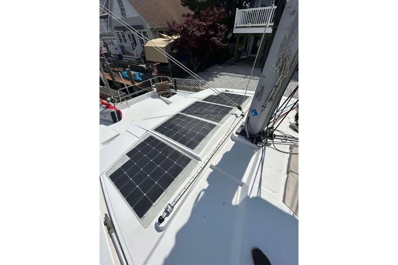 Slide: The Image of Solar panels on a 2018 Bali 4.1 catamaran deck, docked near residential area. - 4