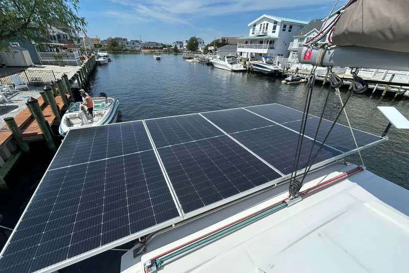 Slide: The Image of Solar panels on a Bali 4.1 catamaran, docked in a scenic marina, 2018 model. - 5