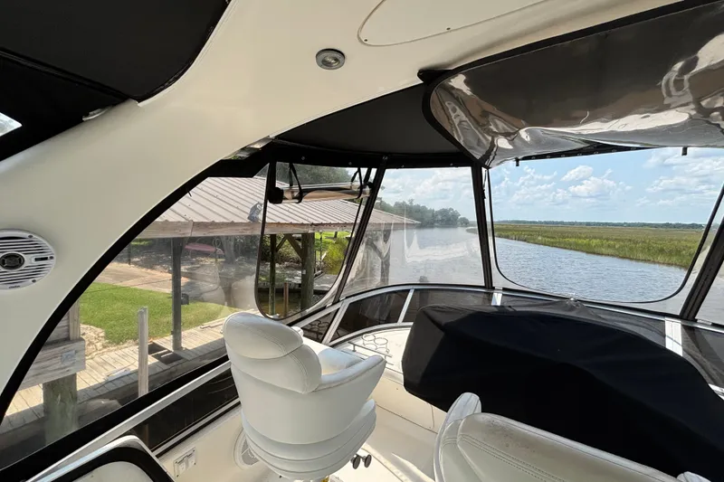 Slide: The Image of Interior view of 2004 Sea Ray 420 Sedan Bridge yacht with scenic river backdrop. - 65