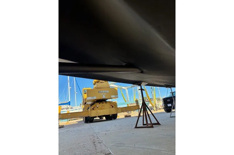 Slide: The Image of 2004 Sea Ray 420 Sedan Bridge under maintenance with crane and support stands. - 92