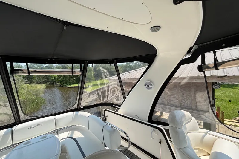 Slide: The Image of Interior view of 2004 Sea Ray 420 Sedan Bridge yacht with scenic waterway backdrop. - 66