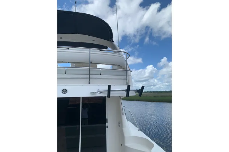 Slide: The Image of Sea Ray 420 Sedan Bridge 2004 by the water, blue sky. - 11