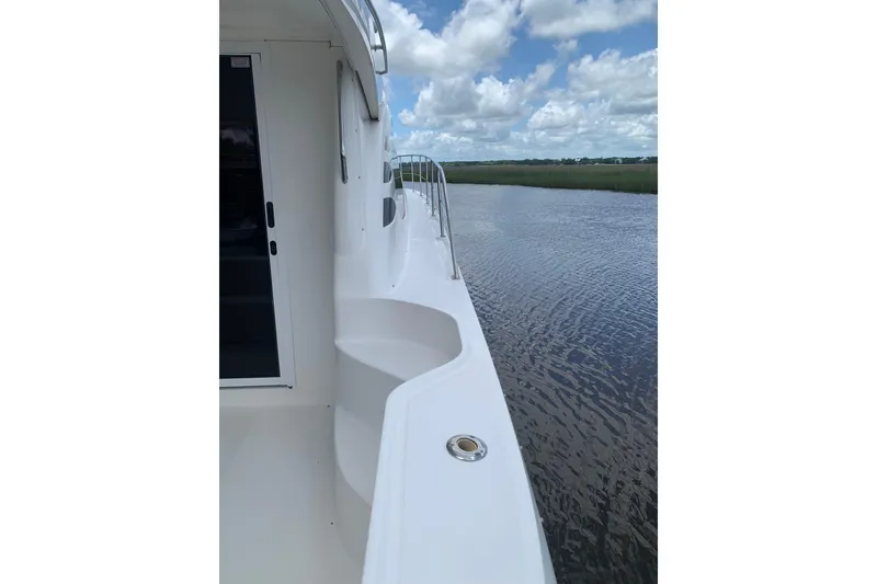 Slide: The Image of 2004 Sea Ray 420 Sedan Bridge yacht deck with scenic water view. - 14