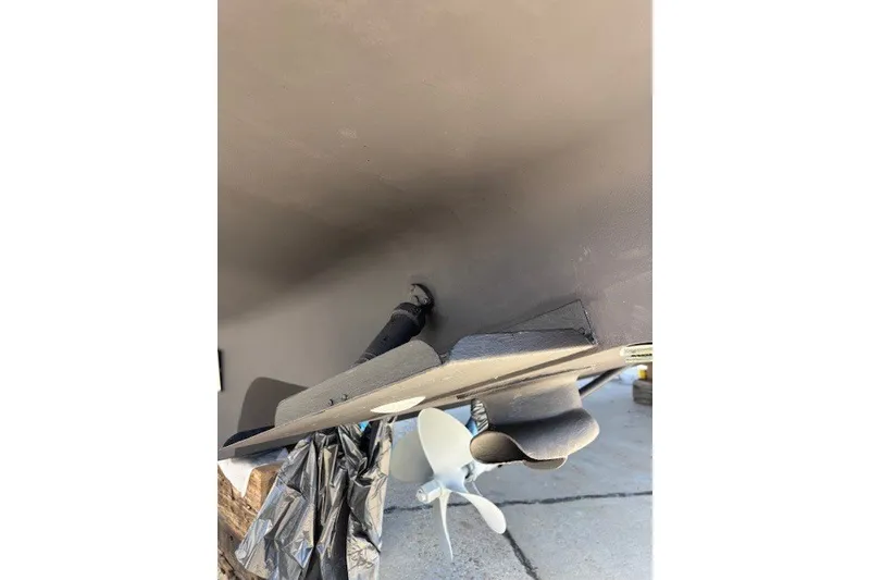 Slide: The Image of 2004 Sea Ray 420 Sedan Bridge underside with propeller and rudder detail. - 74