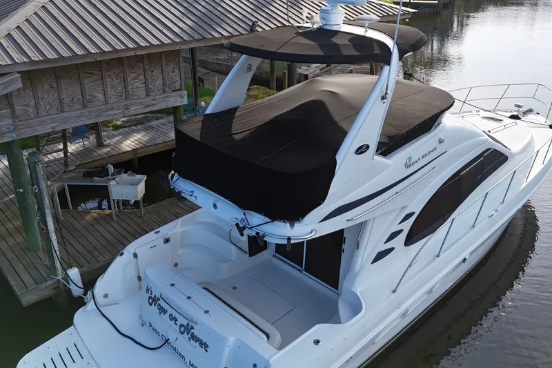 Slide: The Image of 2004 Sea Ray 420 Sedan Bridge yacht docked near wooden pier. - 4
