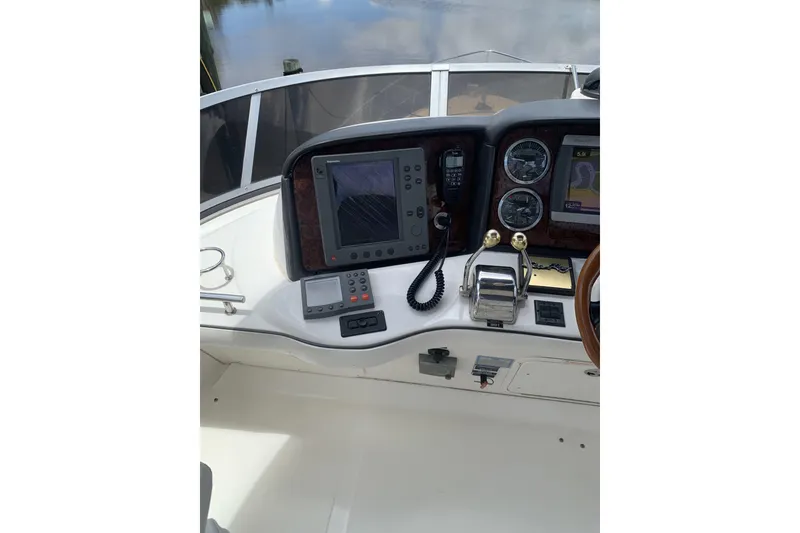 Slide: The Image of 2004 Sea Ray 420 Sedan Bridge helm with navigation equipment and controls. - 26
