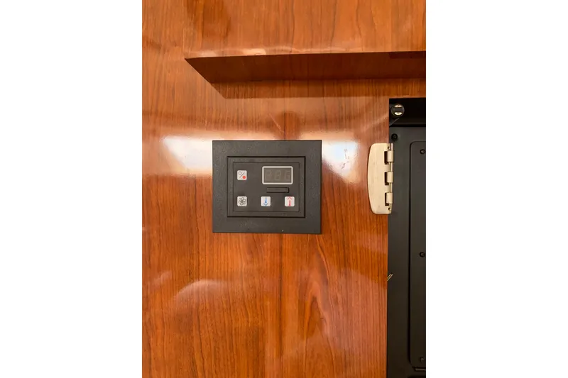 Slide: The Image of Control panel on 2004 Sea Ray 420 Sedan Bridge, mounted on polished wood surface. - 28