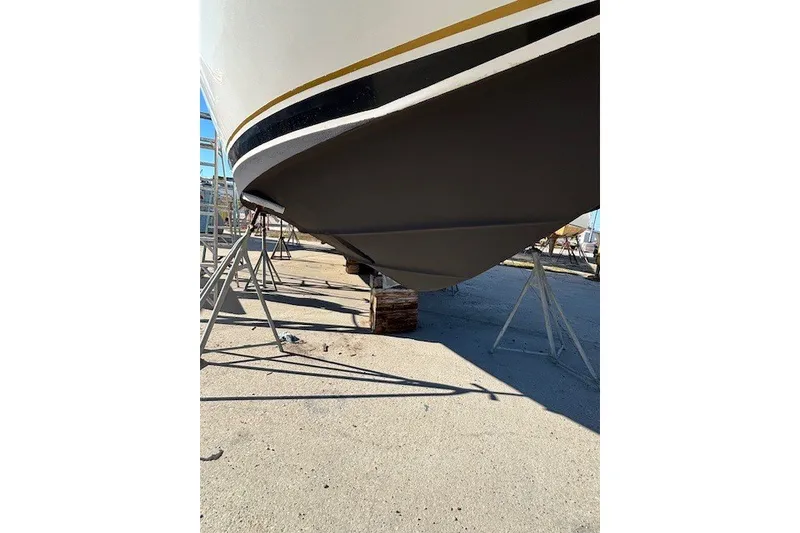 Slide: The Image of 2004 Sea Ray 420 Sedan Bridge boat hull on dry dock stands. - 95