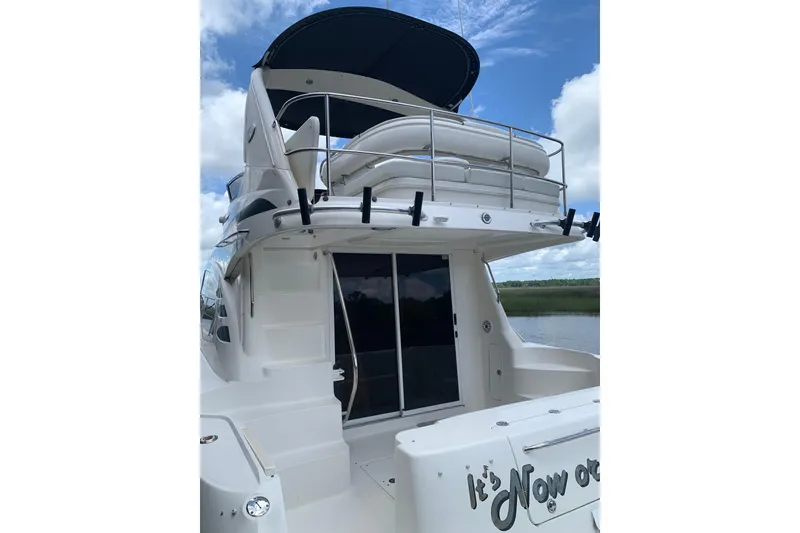 Slide: The Image of 2004 Sea Ray 420 Sedan Bridge yacht with upper deck and sleek design. - 3