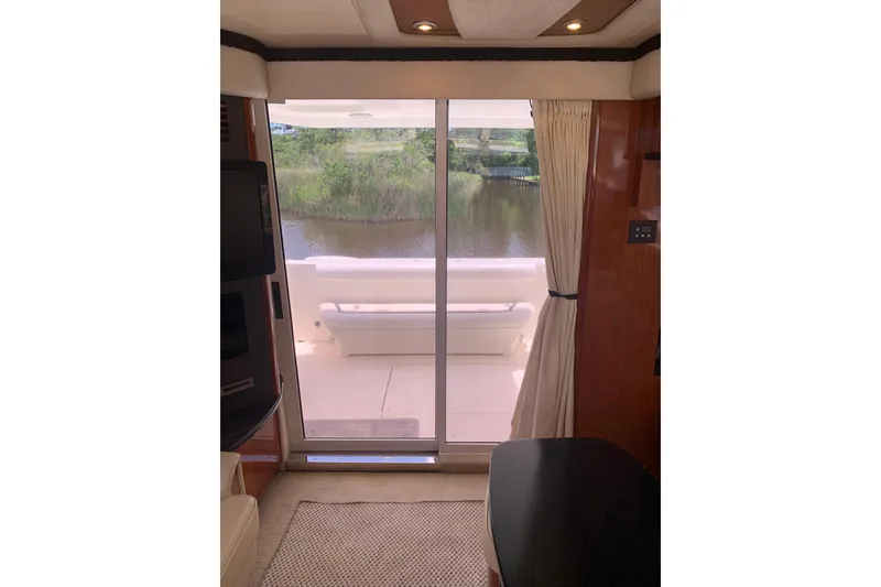 Slide: The Image of Interior view of 2004 Sea Ray 420 Sedan Bridge yacht with sliding glass door. - 33
