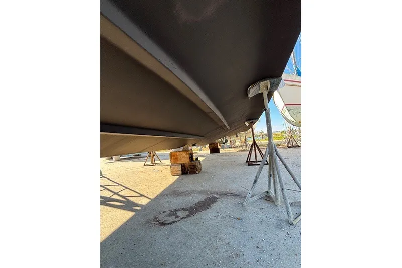 Slide: The Image of 2004 Sea Ray 420 Sedan Bridge hull on stands, boatyard setting. - 100