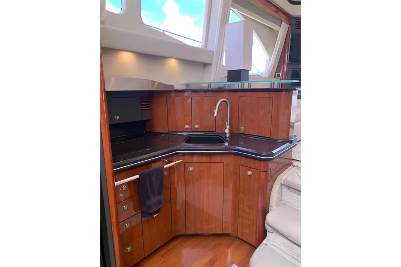 Slide: The Image of Luxurious kitchen interior of 2004 Sea Ray 420 Sedan Bridge yacht with wood cabinetry. - 35