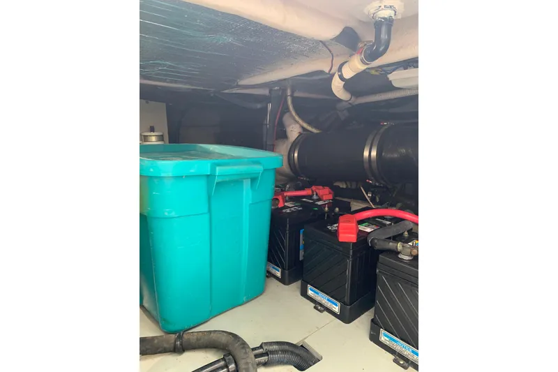 Slide: The Image of Engine room of 2004 Sea Ray 420 Sedan Bridge with batteries and storage container. - 36