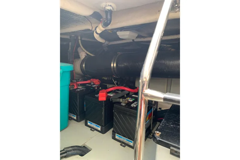 Slide: The Image of Engine room of a 2004 Sea Ray 420 Sedan Bridge showing batteries and wiring. - 37