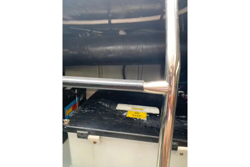 Slide: The Image of Engine compartment of a 2004 Sea Ray 420 Sedan Bridge with visible battery and railing. - 38