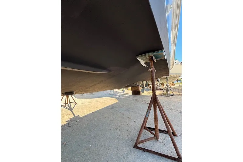 Slide: The Image of 2004 Sea Ray 420 Sedan Bridge boat hull supported on stands. - 101
