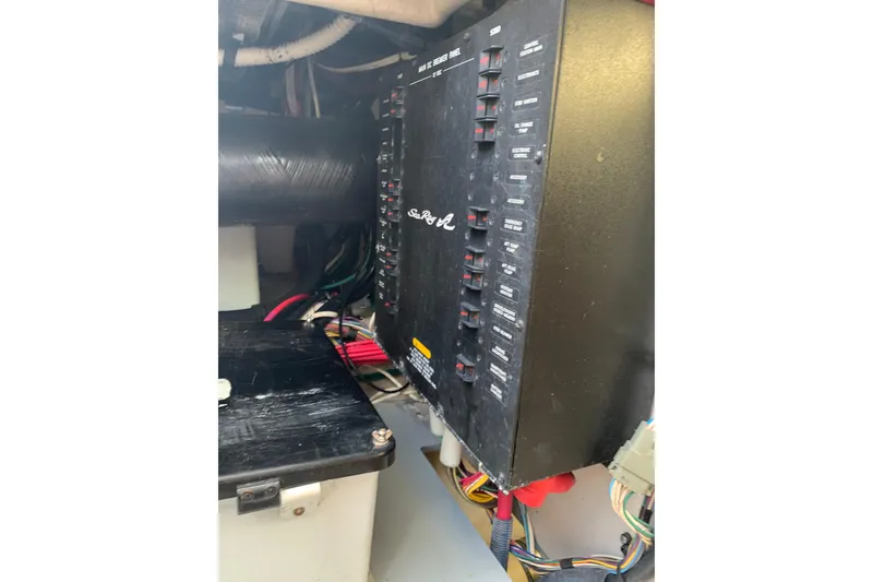 Slide: The Image of Electrical panel of a 2004 Sea Ray 420 Sedan Bridge boat, featuring circuit breakers and wiring. - 39
