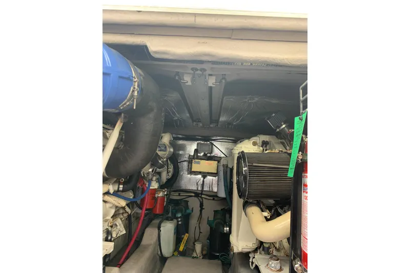 Slide: The Image of Engine room of a 2004 Sea Ray 420 Sedan Bridge, showcasing mechanical components and equipment. - 42