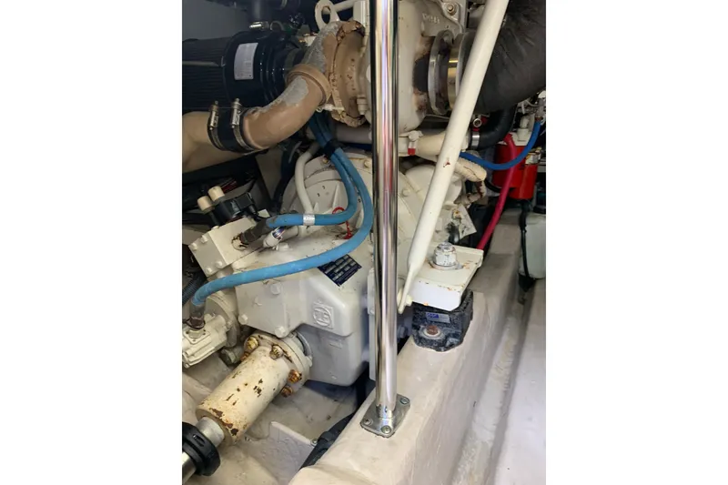 Slide: The Image of Engine compartment of a 2004 Sea Ray 420 Sedan Bridge with visible components and piping. - 44