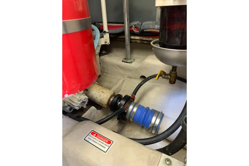 Slide: The Image of Engine compartment of a 2004 Sea Ray 420 Sedan Bridge, showing hoses and components. - 45