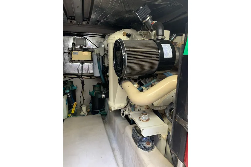 Slide: The Image of Engine room of a 2004 Sea Ray 420 Sedan Bridge, showcasing mechanical components. - 46