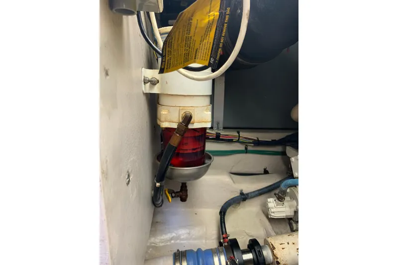 Slide: The Image of Engine compartment of 2004 Sea Ray 420 Sedan Bridge, featuring fuel filter and hoses. - 47