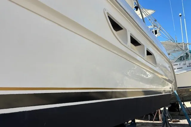 Slide: The Image of 2004 Sea Ray 420 Sedan Bridge boat hull with sleek design and ventilation details. - 83