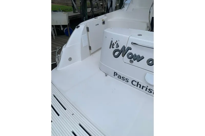 Slide: The Image of 2004 Sea Ray 420 Sedan Bridge boat docked, featuring "It's Now or Never" text. - 5