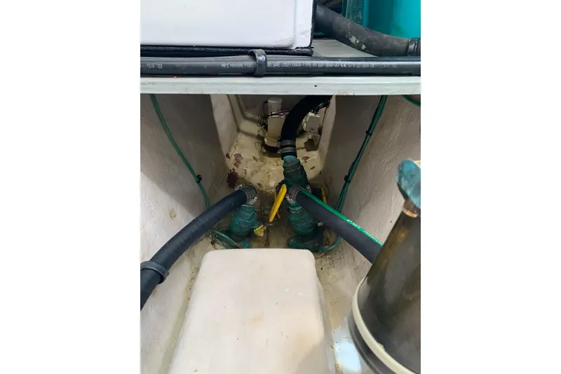 Slide: The Image of Engine compartment of a 2004 Sea Ray 420 Sedan Bridge with visible hoses and fittings. - 51