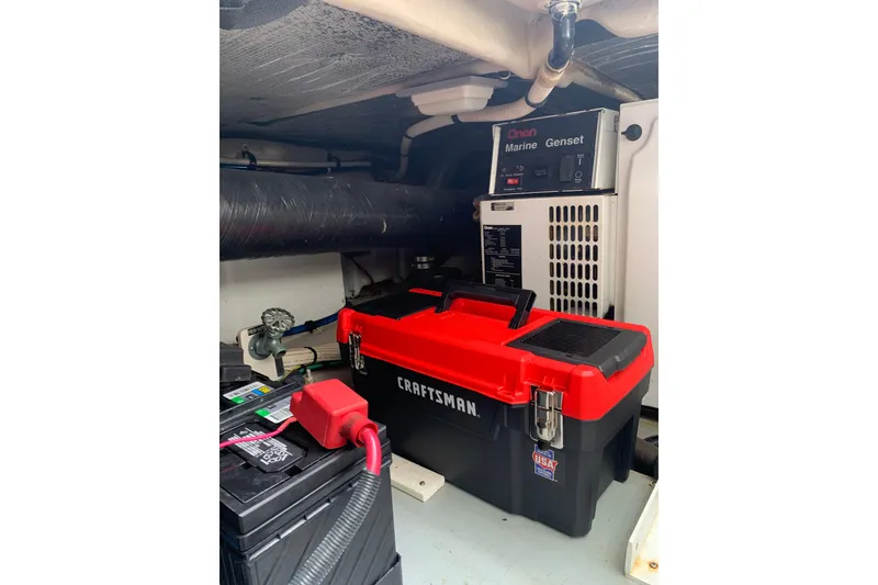 Slide: The Image of Engine room of 2004 Sea Ray 420 Sedan Bridge with Craftsman toolbox and Onan Marine Genset. - 52