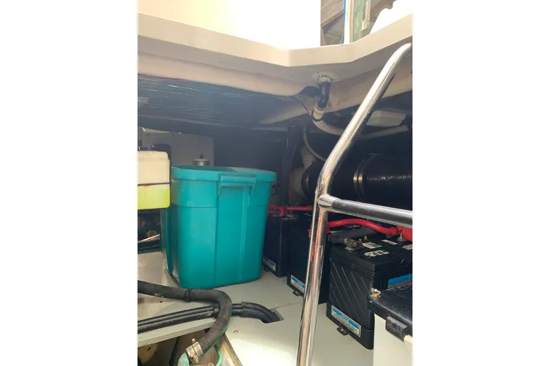 Slide: The Image of Engine room of 2004 Sea Ray 420 Sedan Bridge with storage bin and batteries. - 54