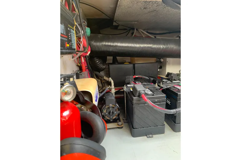 Slide: The Image of Engine room of 2004 Sea Ray 420 Sedan Bridge with batteries and wiring. - 56